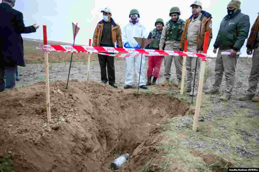 Nagorno-Karabakh -- Workers of the Azerbaijan National Agency for Mine Action (ANAMA) at a phosphorus shell of Armenian forces. Fuzuli district, November 18, 2020