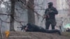 A still photo from RFE/RL Ukrainian Service video (below) showing Ukrainian security forces with a Kalashnikov assault rifle and sniper rifle, respectively, in a confrontation with protesters in Kyiv on February 20, when dozens of Euromaidan supporters were gunned down.