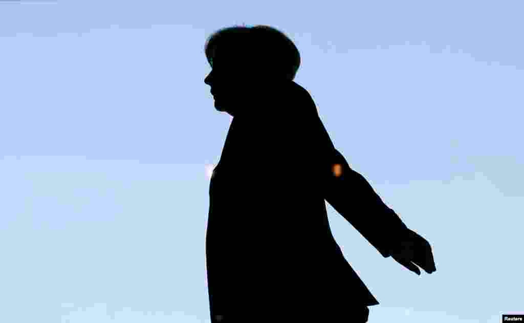 German Chancellor Angela Merkel is silhouetted against the sky as she arrives for a session of the lower house of parliament, the Bundestag, in Berlin on March 20. (Reuters/Fabrizio Bensch)