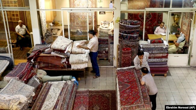 Iranian merchants conduct their business at a carpet market in the old main bazaar in Tehran, Iran, July 23, 2018.