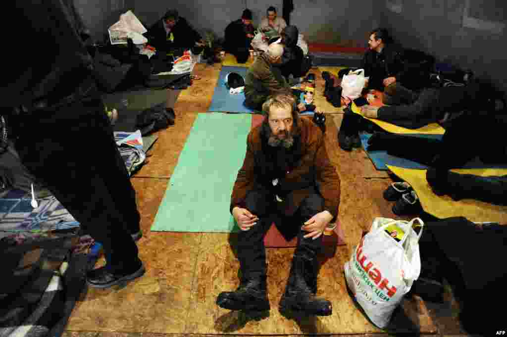 Homeless people rest in a shelter tent provided by a charity organization in St. Petersburg, Russia. (AFP/Olga Maltseva)