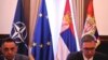 Srpski ministar odbrane Aleksandar Vulin i predsednik Srbije Aleksandar Vučić ispred zastave NATO, EU i Srbije, Beograd