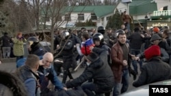 Pro-Russian protesters clash with activists supporting the territorial integrity of Ukraine as Interior Ministry troops attempt to keep them apart during rallies in Kharkiv on April 7.