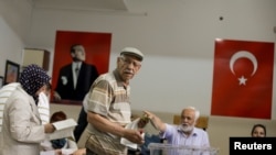 A man waits to cast his ballot during Turkey's presidential and parliamentary elections at a polling station in Ankara on June 24.