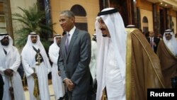 U.S. President Barack Obama and Saudi King Salman walk together following their meetin in Riyadh on April 20. 