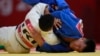 Indonesia Asian Games Judo-Didar Khamza of Kazakhstan, right, competes against Saeid Mollaei of Iran during their men's - 81kg final judo match at the18th Asian Games in Jakarta, Indonesia, Thursday, Aug. 30, 2018.Didar won gold.(AP Photo/Tatan Syuflana)