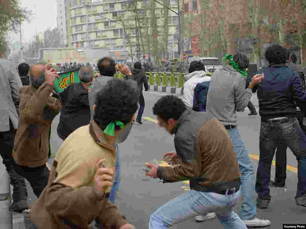 Iran -- Iranian opposition supporters throw stones towards riot policemen during clashes in Tehran, 27Dec2009 - Photo by Sara (Use only with Photographer's name