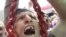 Egypt -- A man holds a noose as he shouts revenge slogans on Tahrir Square, Cairo, 22Jul2011