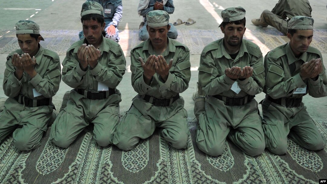 Cadets from the Afghan Local Police pray at the police academy on the outskirts of Jalalabad on June 20.