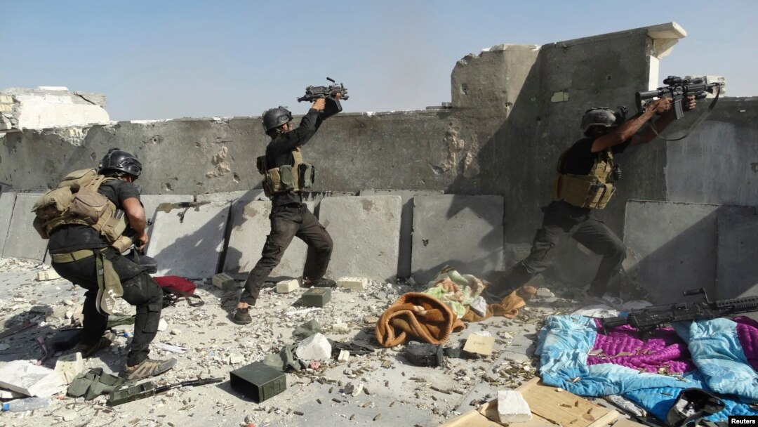 Members of the Iraqi special forces take positions during clashes with the Al-Qaeda-linked Islamic State of Iraq and the Levant (ISIL) in the city of Ramadi on June 19. 