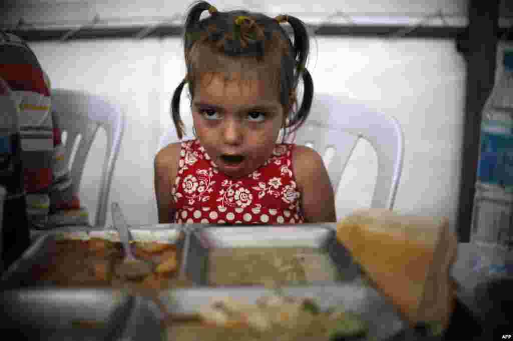 A young Kosovar girl eats her iftar dinner. The holy month ends on the evening of August 7, when Muslims will celebrate Eid al-Fitr.