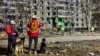 Emergency personnel work at the site of an apartment building hit by a Russian air strike in Kharkiv, Ukraine, on November 8.