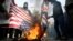 Demonstrators burn the U.S. and British flags during a protest in Tehran after the killing of General Soleimani.