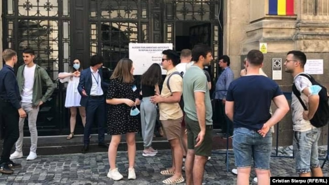 Moldovans prepare to vote at a location in neighboring Romania.