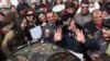 Armenia - A police officer tries to stop environmental activists pitching a tent in Yerevan's Mashtots Park, 13Mar2012.