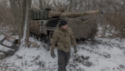 A Ukrainian member of the 68th Jaeger Brigade walks next to a Leopard 1A5 tank near Pokrovsk, Donetsk region, on December 13.