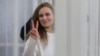 Katsyaryna Andreyeva signals to supporters in the courtroom during her trial in Minsk in February 2021.