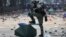 CHINA HONG KONG PROTESTS -- A riot police officer stomps on an umbrella used by pro-democracy protesters during clashes outside the Hong Kong Polytechnic University (PolyU), in Hong Kong, November 18, 2019.