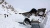 FILE: A vehicle is seen covered with snow after avalanches killed at least 157 people in Salang tunnel in February, 2010.