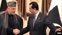 Pakistani Prime Minister Yousuf Raza Gilani (right) meets with Afghan President Hamid Karzai in Islamabad.