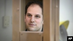 Wall Street Journal reporter Evan Gershkovich stands in a glass cage in a courtroom at the Moscow City Court on December 14.