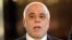 Iraqi Prime Minster Haidar al-Abadi speaks to the press at the airport in Baghdad before leaving for the United States on April 13.