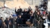 Displaced Palestinians cheer as they return to Rafah in the southern Gaza Strip on January 19.