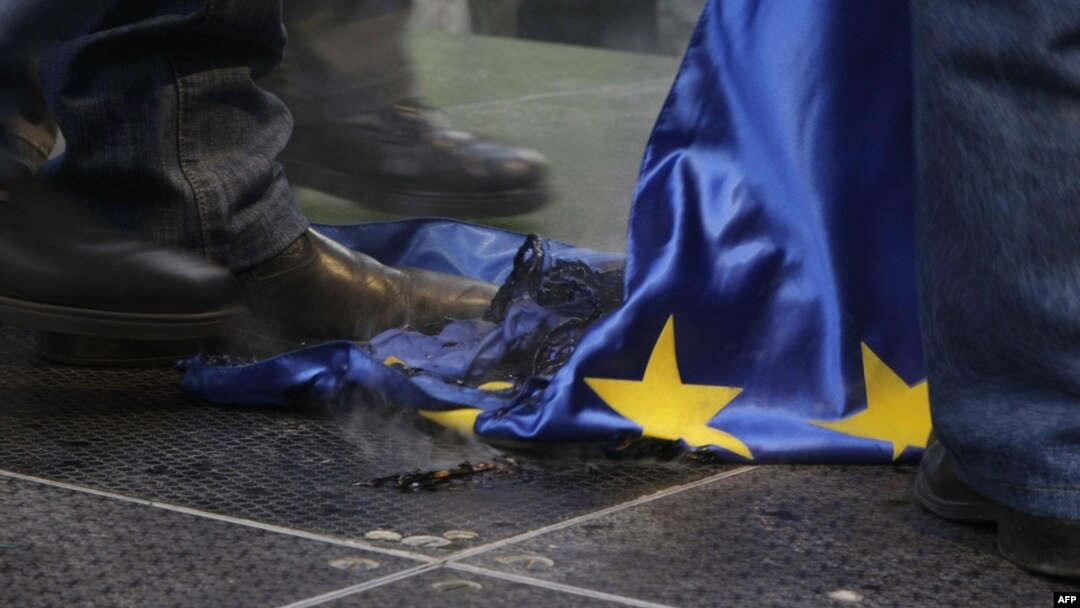 Hungarian protesters trample a burnt EU flag at a rally called by the right-wing party Jobbik in front of the EU headquarters in downtown Budapest in January 2012.