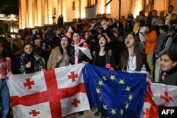 Protestors chant as they demonstrate outside the Georgian parliament in Tbilisi on May 18.
