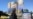 A woman walks past a billboard referring to the Strait of Hormuz in Tehran's Vanak Square on April 15.