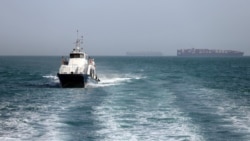 In this picture obtained from Iran's semiofficial ISNA news agency the Iranian-flagged passenger vessel Atlas Pishro cruises near ships anchored in the Strait of Hormuz on May 2. 