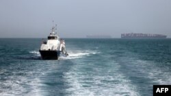 In this picture obtained from Iran's semiofficial ISNA news agency the Iranian-flagged passenger vessel Atlas Pishro cruises near ships anchored in the Strait of Hormuz on May 2. 