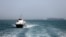 In this picture obtained from Iran's ISNA news agency and taken on May 2, 2026, the Iran-flagged passenger vessel Atlas Pishro cruises near ships anchored in the Strait of Hormuz off Bandar Abbas in southern Iran.
