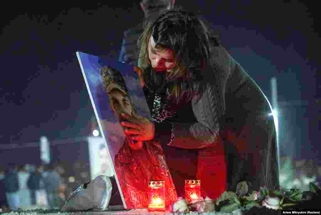 A woman mourns at the grave of a young soldier during a candlelight vigil in Armenia&rsquo;s Yerablur cemetery on the eve of the anniversary. A reported 4,025 ethnic Armenian fighters were killed in the conflict, along with 88 civilians. Amnesty International accused both sides of war crimes, including gruesome executions.&nbsp; &nbsp;