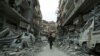 A Syrian child walks down a street past rubble from destroyed buildings in the rebel-held town of Douma in the eastern Ghouta enclave on the outskirts of Damascus earlier this week.