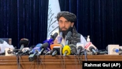 Taliban spokesman Zabihullah Mujahid speaks at at his first news conference in Kabul on August 17. 