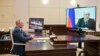 Russian President Vladimir Putin listens to Prime Minister Mikhail Mishustin during a teleconference at the Novo-Ogaryovo residence outside Moscow on April 30. Mishustin announced in the video call that he would self-isolate because he had tested positive for the coronavirus. 