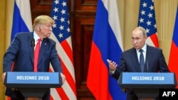 Then-President Donald Trump (left) listens as Russian President Vladimir Putin speaks at a joint press conference after a meeting in Helsinki in July 2018.