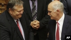 Greek Prime Minister George Papandreou (right) is congratulated by Finance Minister Evangelos Venizelos in Athens.