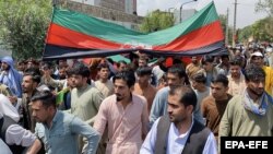 Afghans hold national flags as they celebrate Independence Day in Kabul on August 19. 