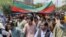 Afghans hold national flags as they celebrate Independence Day in Kabul on August 19. 