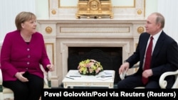 German Chancellor Angela Merkel and Russian President Vladimir Putin talk in the Kremlin on January 11. 