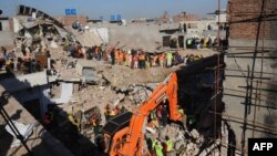 Rescue workers continue their search for victims in the debris of a collapsed building in Lahore.