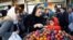 Iran -- Iranians buy items to celebrate the upcoming Persian new year Norouz at a street market in Tehran, March 18, 2016