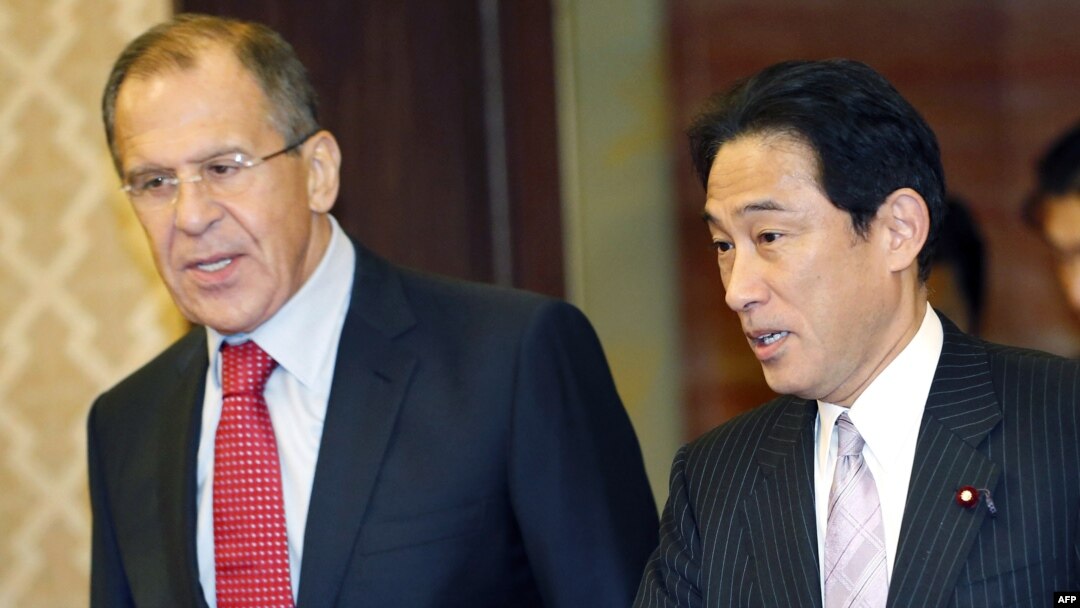 Japanese Foreign Minister Fumio Kishida (right) talks with his Russian counterpart, Sergei Lavrov, prior to their meeting in Tokyo.