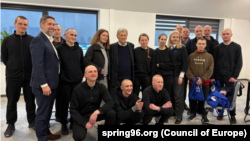 A photo containing several of the 250 prisoners released by Belarus on March 19, 2026, as part of a deal negotiated with US Special Envoy John Coale (center, back row).