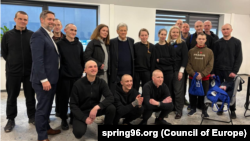 Belarusda azadlığa çıxan məhbusların bir neçəsi Con Koul ilə birlikdə.