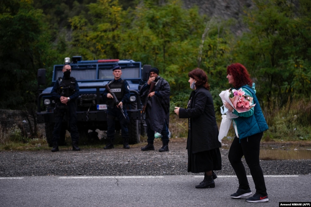 Serbian women walk past Kosovar police after crossing the border on foot in Jarinje on September 28. Serbian President Aleksandar Vucic has warned NATO that Serbia will intervene in Kosovo if Serbs there come under serious threat from the ethnic Albanian majority.