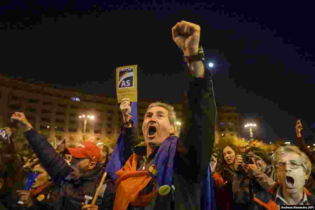 Antigovernment protesters shout &quot;Democracy is under siege!&quot; in Bucharest, Romania, on November 5. Tens of thousands of Romanians gathered in Bucharest and other cities to protest government plans to introduce legislation they say will weaken efforts to root out corruption. (AP/Andreea Alexandru)