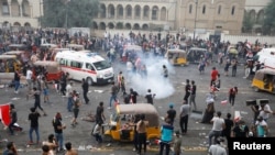 Demonstrators disperse as Iraqi Security forces use tear gas during a protest over corruption, lack of jobs, and poor services, in Baghdad, Iraq October 25, 2019. 